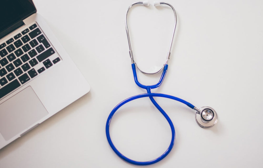 Stethoscope and laptop on a desk